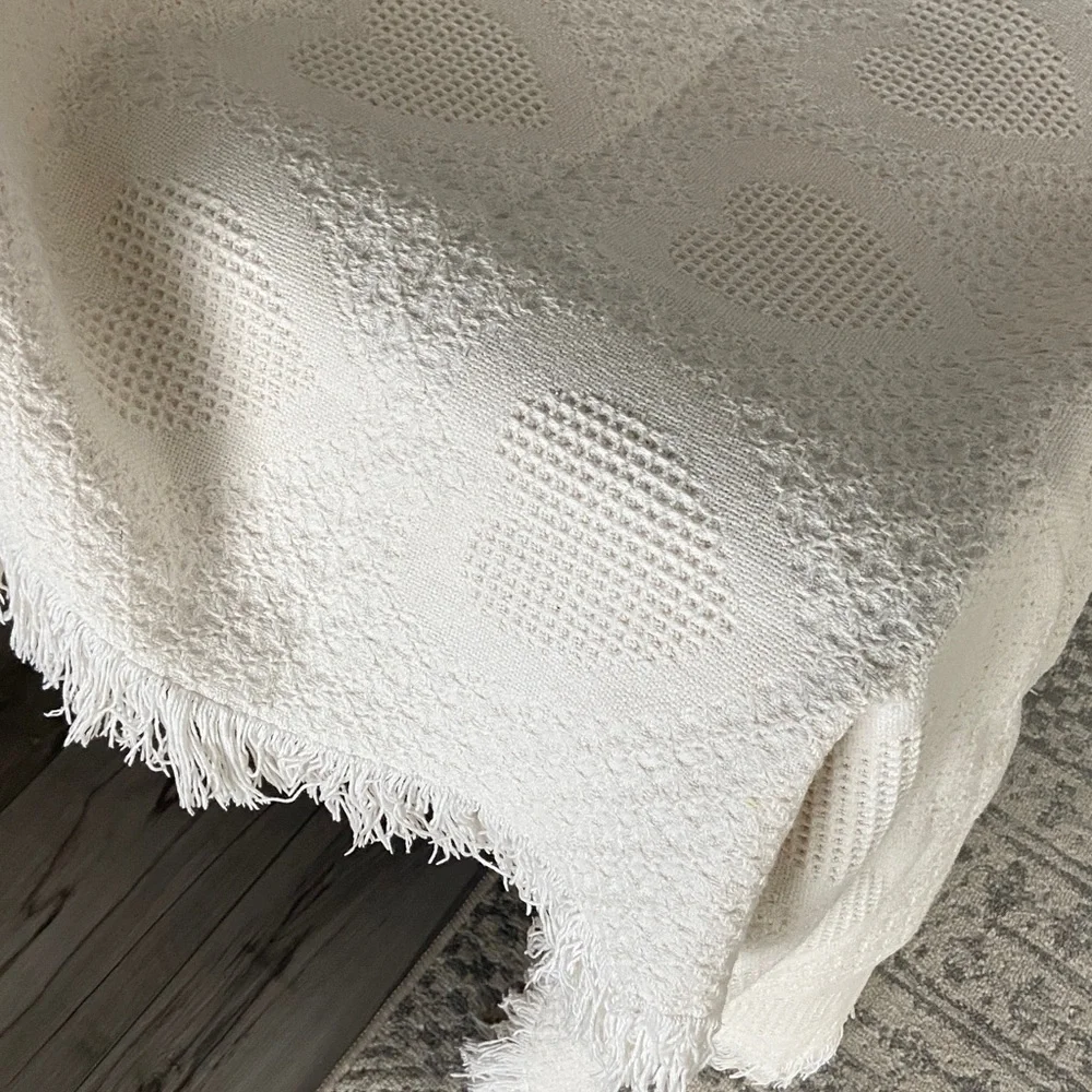 Beautiful white blanket with subtle heart detail.